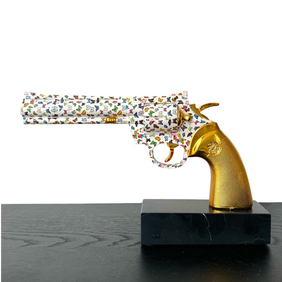 Sculpture of a gun with butterflies