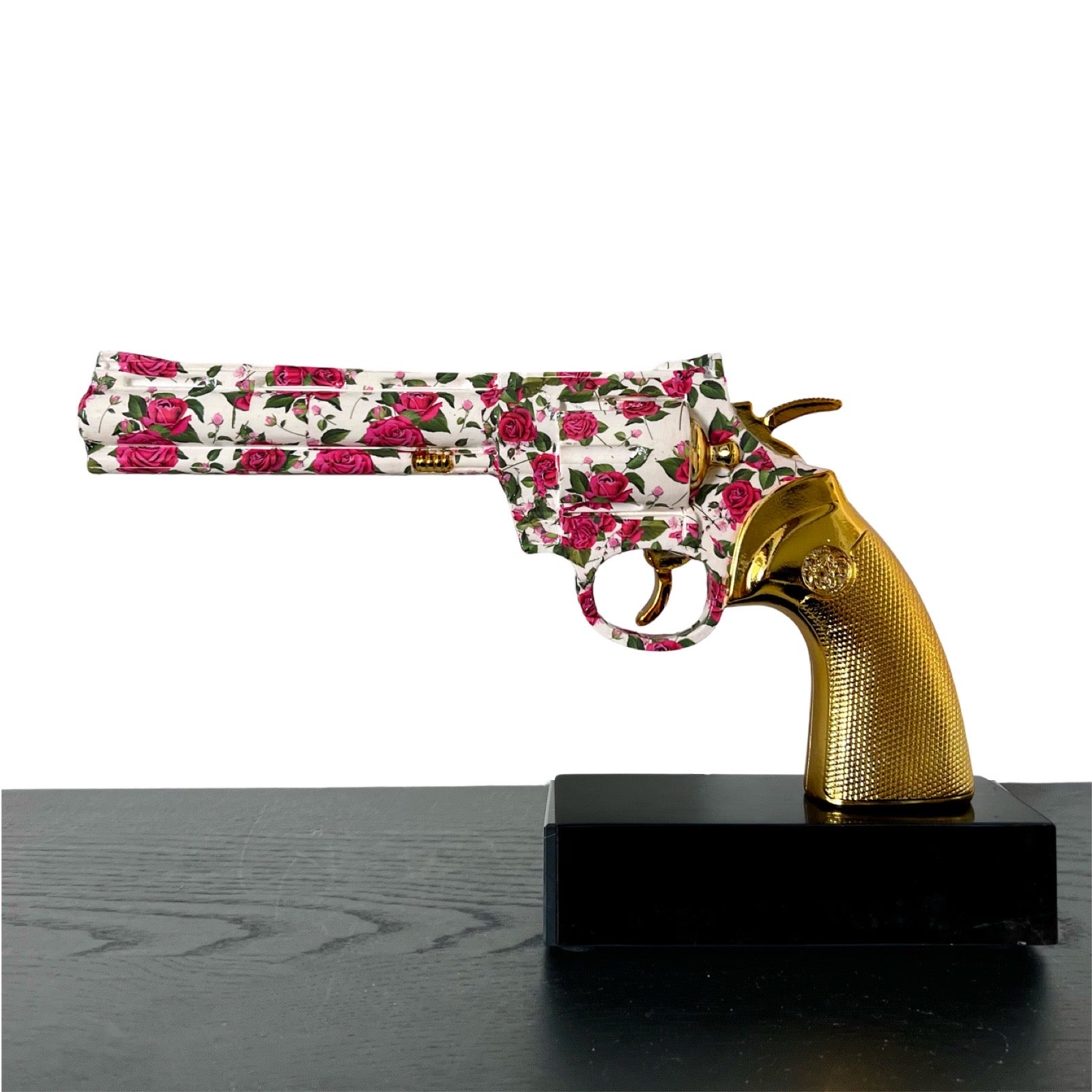 Sculpture of a gun with roses