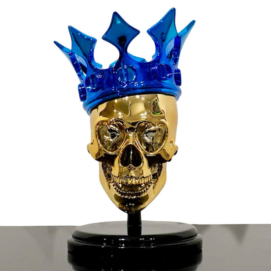 Sculpture of a golden skull with blue Christian Dior crown