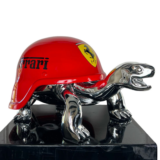 Zilver schildpad beeld met rode helm met Porsche logo